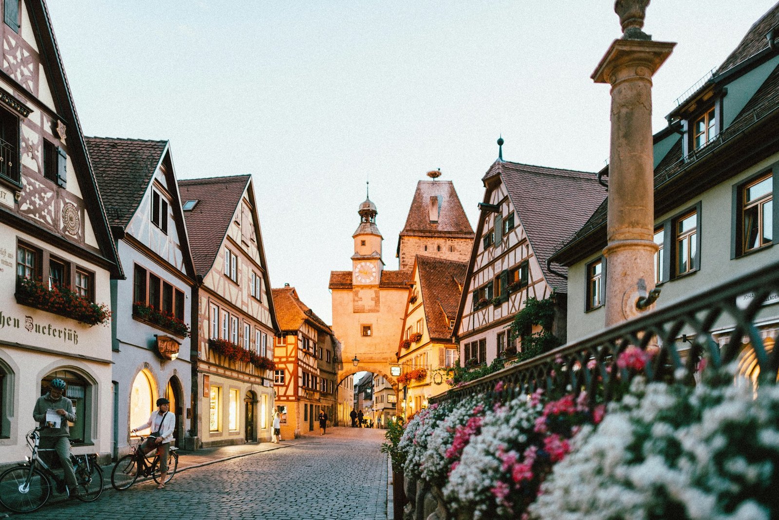 A quiet European street of old stone buildings in evening light